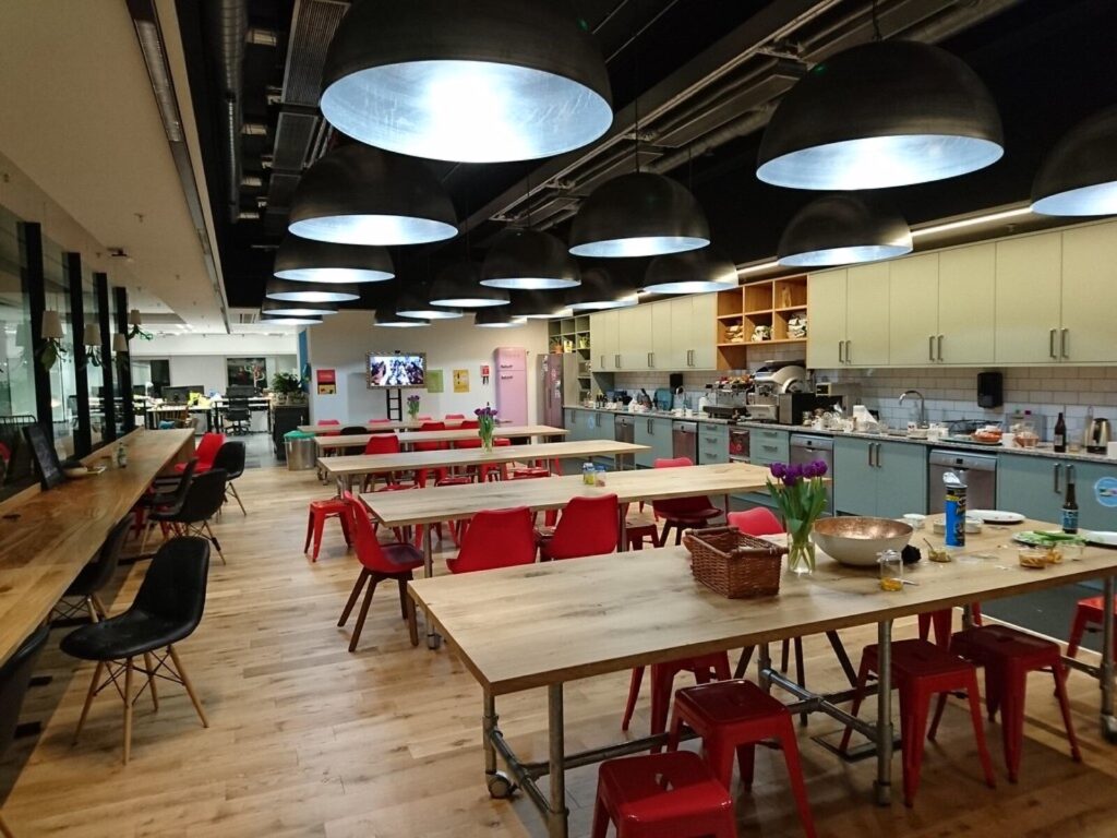 Communal tables and a shared kitchen in a co-working office